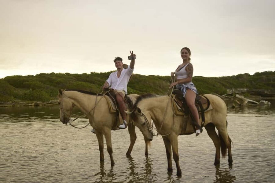 Punta Cana: Horseback Ride to Macao Beach - Riding through a traditional village