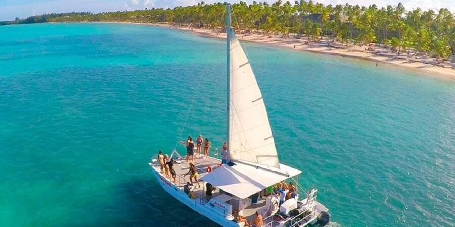 Punta Cana: Party Boat with snorkel and open bar included - Leaving shore along the Bávaro coastline